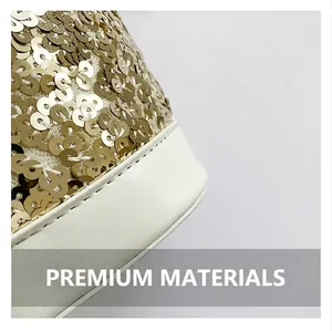 Detailed macro view of golden sequins on white mesh fabric with smooth leather piping