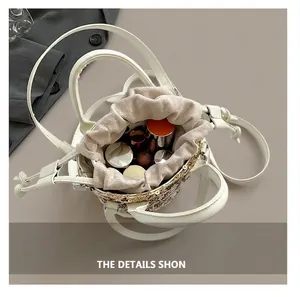 Internal view showing capacity of the sequin bucket bag with lipsticks and foundation