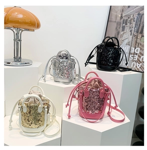 Detailed view of sequined drawstring bucket bags in silver, black, gold, and pink colors