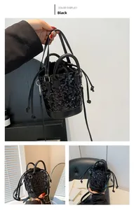 Detail of black sequin bucket bag featuring drawstring closure and flat PU leather base