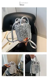 Close-up of silver sequin bucket bag with drawstring closure and chain strap