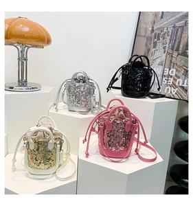 Detailed display of sequin bucket bags in gold, silver, black, and pink with chain straps