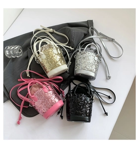 Top view of sequined mini bucket bags in gold, silver, pink and black with chain straps