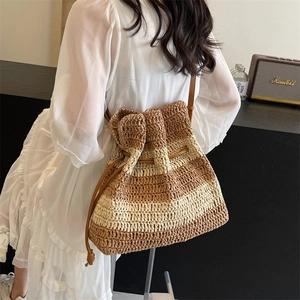 Striped straw shoulder tote bag with brown straps for beach vacations and daily use