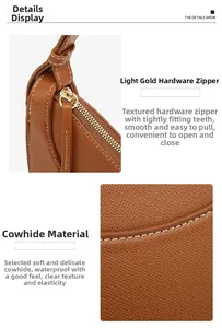 Detail view of premium brown cowhide leather with lychee texture and gold metal zipper