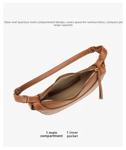 Detail view of brown leather shoulder bag interior with main compartment and small pocket