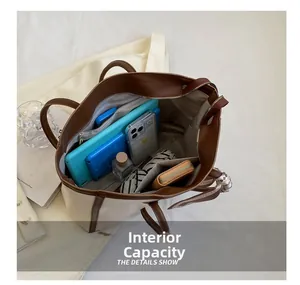 Detail view of large tote bag interior with multi-compartment storage and silk scarf