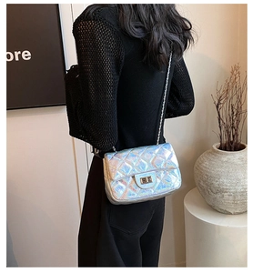 Close-up of holographic silver quilted crossbody bag with stylish chain strap and lock