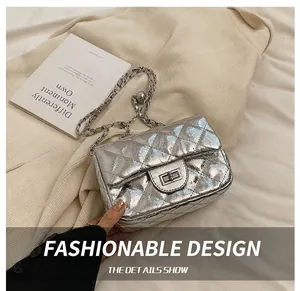 Macro detail of silver quilted chain bag with metallic finish and square twist lock