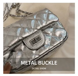 Detail of silver laser finish quilted leather and metallic twist lock on chain bag