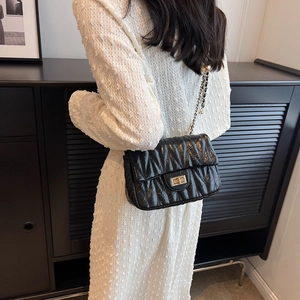 Fashionable black quilted matelassé crossbody bag with gold chain and twist lock