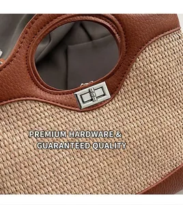 Detail of silver twist lock and woven texture on brown leather bucket bag