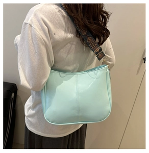 Detail of mint green PU leather crossbody bag with ethnic embroidered wide strap