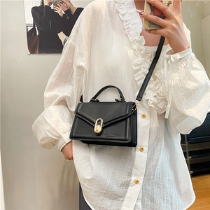 Classic black leather crossbody bag with a gold metal lock and top handle for women