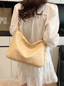 Minimalist beige PU leather large tote bag for women showing a stylish shoulder carry