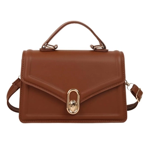 Minimalist caramel brown leather handbag with golden oval lock and detachable strap
