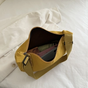 Detailed interior of a ginger yellow nylon tote bag showing spacious storage capacity