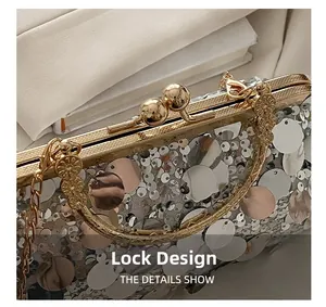 Detailed view of the sparkling sequin pillow bag featuring an elegant gold ball clasp design