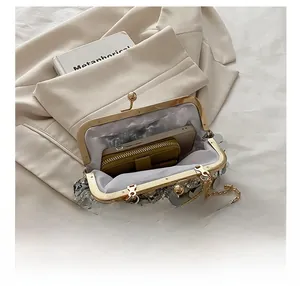 Detailed view of silver sequin evening bag interior with phone and wallet inside