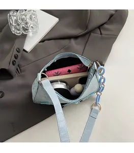 Spacious interior of blue pearlescent tote bag showing room for phone and cosmetics