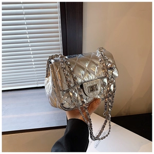 Detail of silver laser finish quilted crossbody bag with metal chain and rectangular lock