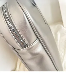 Close-up of metallic silver PU leather bag showing neat stitching and quality zipper