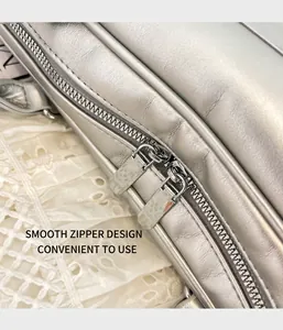 Detail shot of a silver metallic briefcase featuring high-quality dual metal zippers