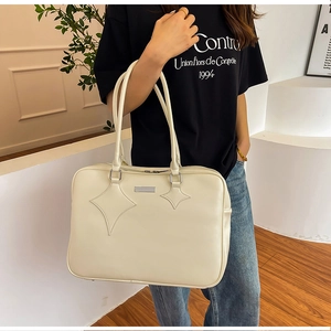 Off-white large briefcase bag with star leather patch detail shown in casual setting