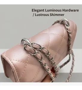 Detailed macro view of the dusty pink quilted leather texture and silver chain strap