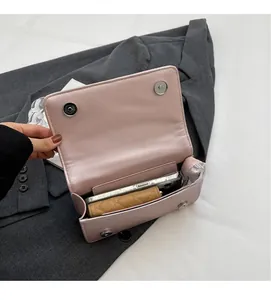 Interior view of small quilted bag showing storage capacity for phone and wallet