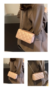Detail view of pink quilted crossbody bag with chain strap and elegant metallic text