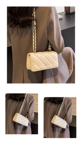 Detail of beige quilted chain bag featuring elegant diamond lattice and metal strap
