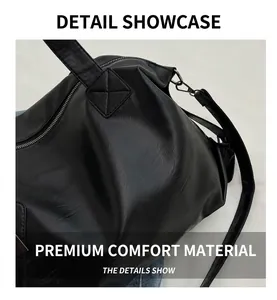 Close-up of black leather tote with litchi texture and reinforced stitching detail
