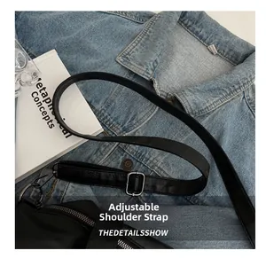 Detail of adjustable black leather strap with silver metal buckle on a large tote bag
