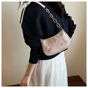 Close-up of pink embossed butterfly hobo bag with matching acrylic chain strap