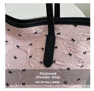 Close-up of thickened black leather strap and pink pleated fabric with bow patterns