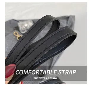 Close-up of durable black leather shoulder strap with neat double-row stitching detail
