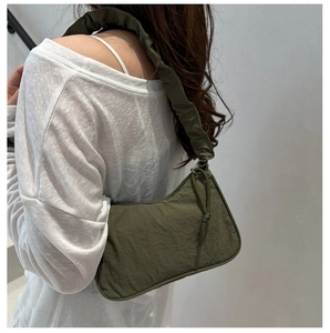 Olive green nylon shoulder bag with pleated ruffle strap and drawstring detail