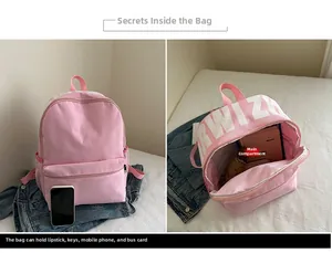 Pink nylon backpack detail showing spacious interior capacity for daily essentials