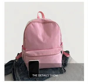 Detailed comparison showing pink canvas backpack size next to a smartphone