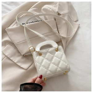 Detailed macro view of white quilted faux leather texture and gold protective base studs