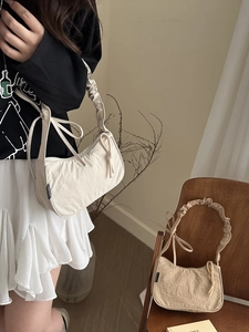 Fashionable pleated shoulder bag with oversized handle and drawstring in cream and khaki