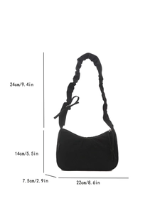 Black pleated tote bag with bow detail showing dimensions 22x14x7.5 cm and handle height