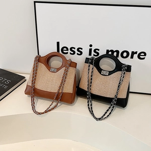 Fashion straw bucket bag with metal chain strap and leather trim in brown and black