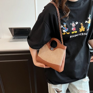 Brown leather and woven straw bucket bag with circular handle and chain strap for women