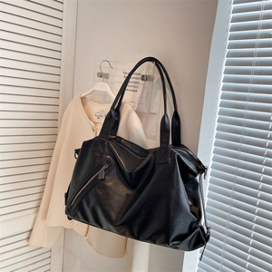 Large black leather tote bag with side zipper pocket for casual commute and travel