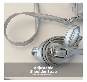 Detail view of adjustable silver shoulder strap with metal buckle on moon bag