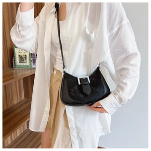 Stylish black crescent underarm bag with faux fur texture and silver buckle accents
