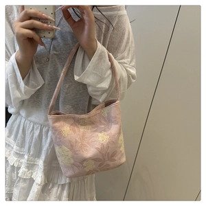 Close-up detail of Chinese style pink floral tote bag with embroidery on canvas fabric