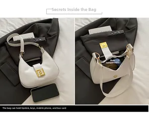 Detailed view of the internal storage of the white crescent bag with golden metal hardware